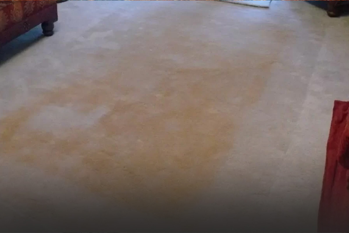 What is the cause of carpet yellowing after washing?